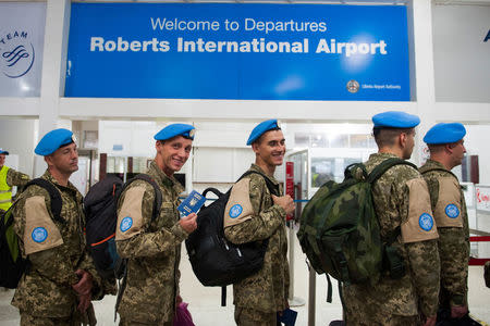 Members of the Ukrainian Aviation Unit deployed in the United Nations Mission in Liberia (UNMIL) wait to check-in at the Roberts international Airport, before flying back to Ukraine, outside Monrovia, Liberia February 9, 2018. Albert Gonzalez Farran/UNMIL/Handout via REUTERS