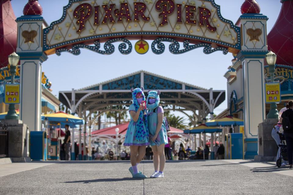 Two women in costume take a selfie.