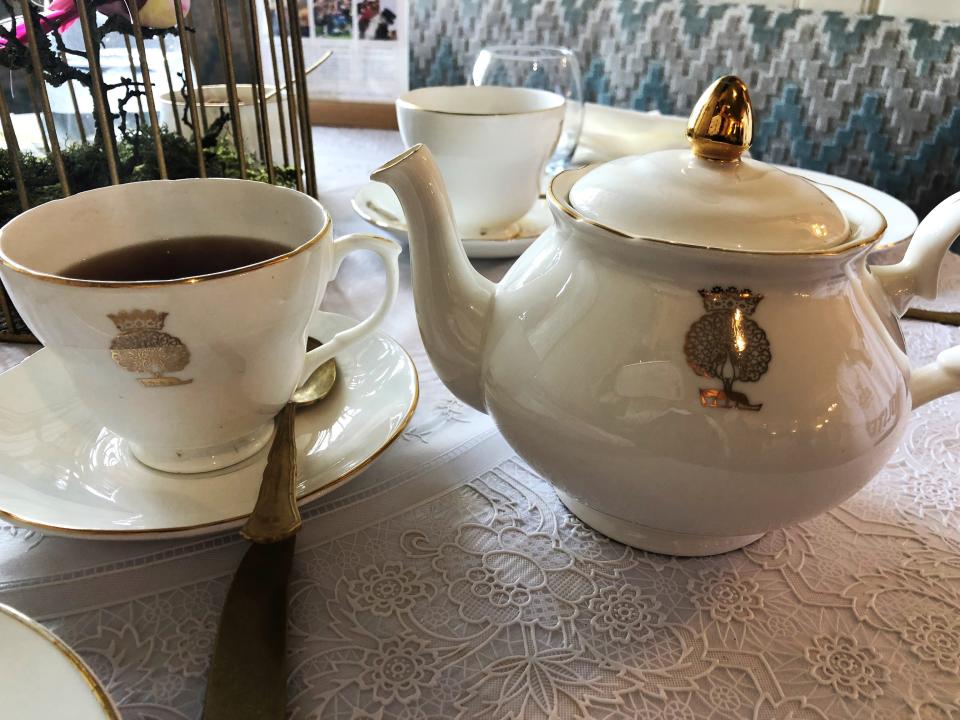 A teapot with a matching cup and saucer.