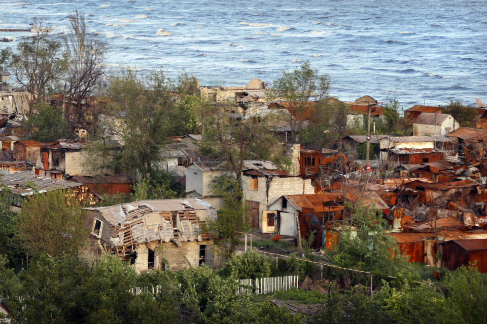 Heavily-damaged private houses are seen on the shore of the Sea of Azov in Mariupol, in territory under the government of the Donetsk People's Republic, eastern Ukraine, Saturday, May 21, 2022. (AP Photo/Alexei Alexandrov)