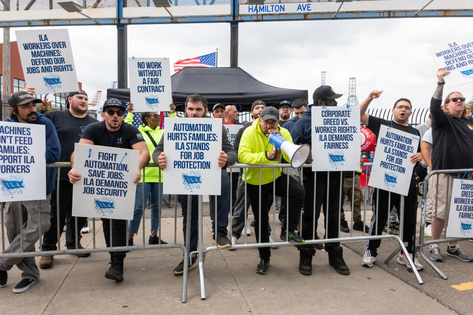 NEW YORK, NEW YORK - OCTOBER 02: Striking workers at the Red Hook Container Terminal in Brooklyn gather after members of the International Longshoremen’s Association, or ILA, began walking off the job yesterday after 12:01 a.m. ET on October 02, 2024 in Brooklyn, New York. The strike of over 50,000 workers at ports along the East Coast and Texas comes after the just-expired master contract with the United States Maritime Alliance, or USMX. Workers are striking over wages, automation, and other issues. (Photo by Spencer Platt/Getty Images)