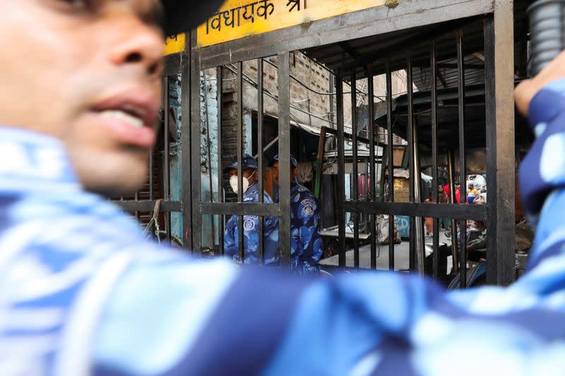 Members of Rapid Action Force (RAF) stand guard at an alley after Wednesday's demolition of illegal encroachments in Jahangirpuri