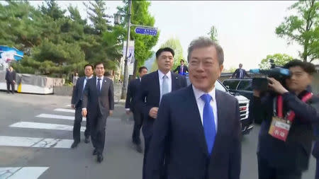 South Korean President Moon Jae-in greets supporters in Seoul, as he makes his way to the inter-Korean summit, in this still frame taken from video, April 27, 2018. Host Broadcaster via REUTERS TV