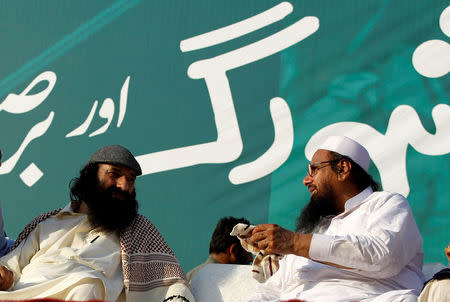 Syed Salahuddin (L), leader of the United Jihad Council, speaks with Hafiz Muhammad Saeed, chief of the banned Islamic charity Jamat-ud-Dawa, during a protest which Pakistani broadcast media were forbidden to cover in Islamabad, Pakistan, July 20, 2016. Picture taken July 20, 2016. REUTERS/Caren Firouz