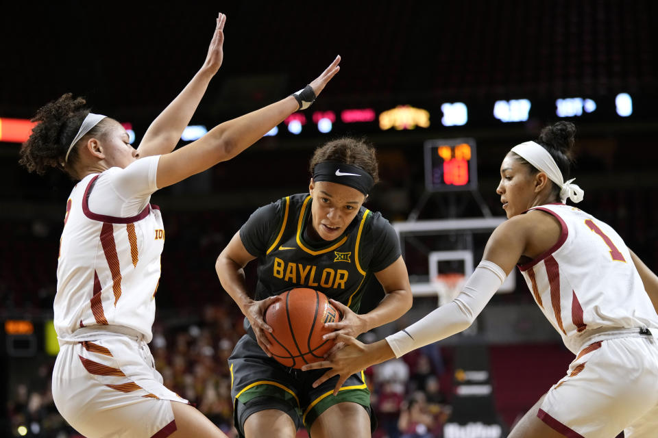 Baylor guard Jada Walker, drives between Iowa State guard Arianna Jackson, left, and forward Jalynn Bristow, right, during the first half of an NCAA college basketball game, Saturday, Jan. 13, 2024, in Ames, Iowa. (AP Photo/Charlie Neibergall)