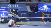 Alexander Zverev, of Germany, sits on the court after losing a point to Pablo Carreno Busta, of Spain, during a men's semifinal match of the US Open tennis championships, Friday, Sept. 11, 2020, in New York. (AP Photo/Seth Wenig)