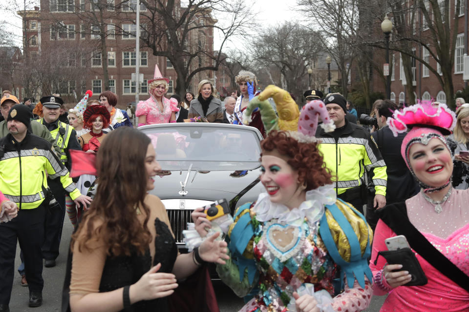 Actor and director Elizabeth Banks, center in car, is paraded through Harvard Square as she is honored as the 2020 Woman of the Year by Harvard University's Hasty Pudding Theatricals, Friday, Jan. 31, 2020, in Cambridge, Mass. (AP Photo/Elise Amendola)