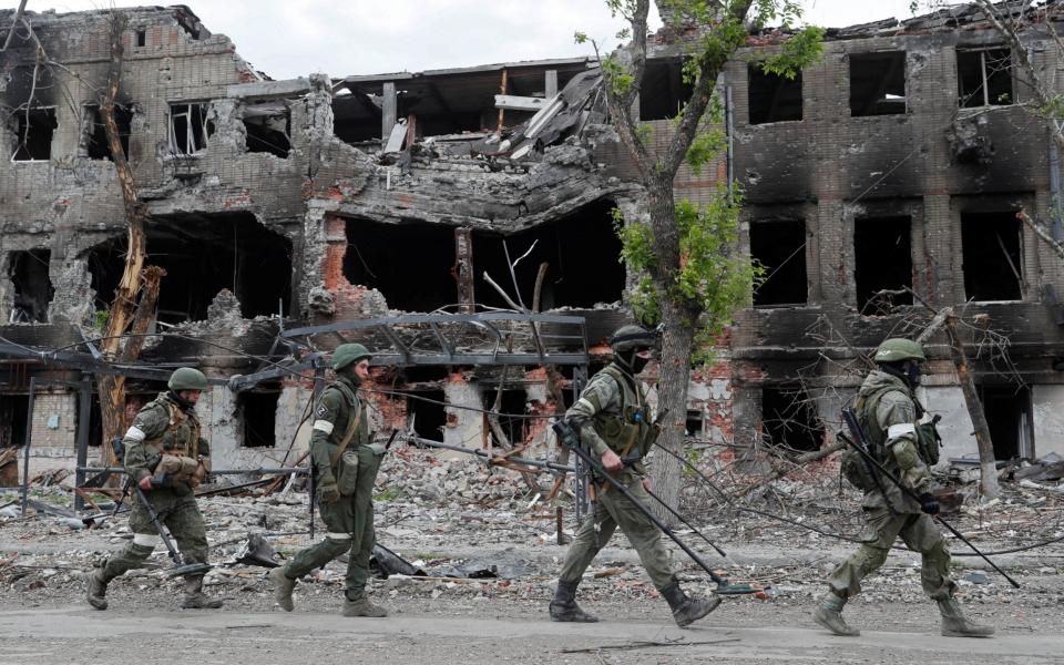 Russian service members demine the territory of Azovstal steel plant in Mariupol - ALEXANDER ERMOCHENKO/REUTERS