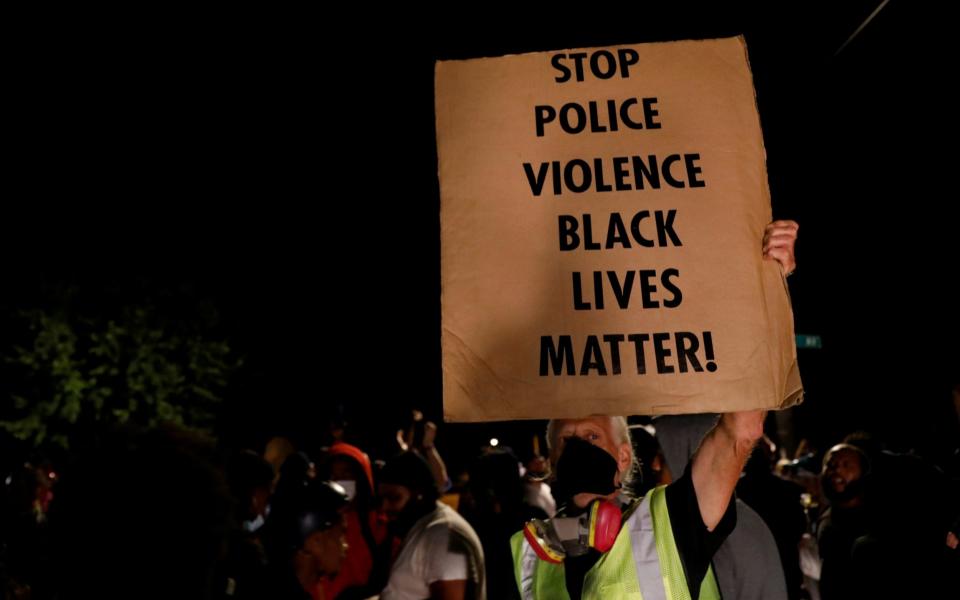 A protester calls for the end of police brutality and violence in Kenosha - BRENDAN MCDERMID /REUTERS