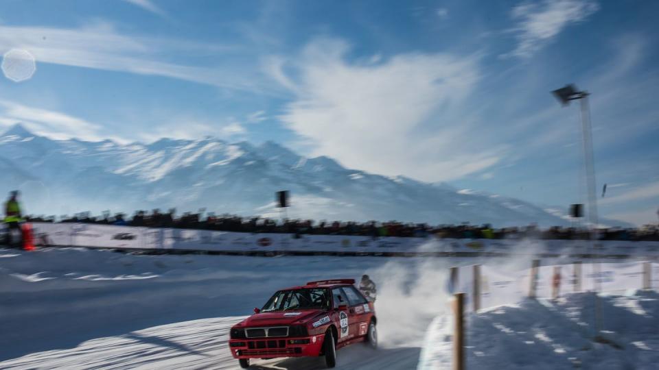 a red car driving on a road