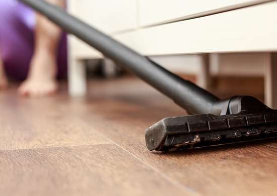 Vaccuuming under furniture with a long handle attachment