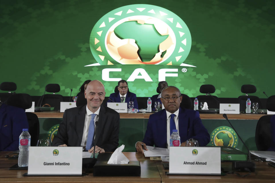 Confederation of African Football president Ahmad Ahmad of Madagascar, right, and FIFA president Gianni Infantino pose for a photo during the Confederation of African Football general assembly in Cairo, Egypt, Thursday, July 18, 2019. The African soccer body is holding its first major meeting since announcing that FIFA will send a senior official to lead a clean-up of the scandal-plagued organization in an unprecedented move for soccer. The Confederation of African Football, whose president is facing numerous allegations of corruption amid the crisis, is holding its general assembly on Thursday in Cairo on the eve of the African Cup final. (AP Photo/Hassan Ammar)