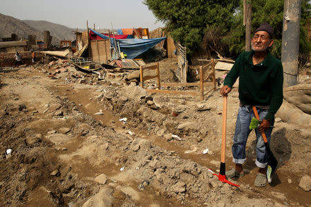 Leon Mendoza stands next to his destroyed home, after rivers breached their banks due to torrential rains, causing flooding and widespread destruction in Huachipa, Lima, Peru, March 26, 2017. REUTERS/Mariana Bazo