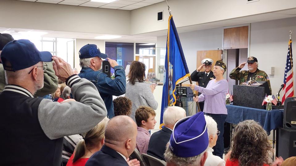 Veterans of the Coast Guard salute as the U.S. Coast Guard flag is presented Friday during the Veterans Day Ceremony at the Texas Panhandle War Memorial Center in Amarillo.