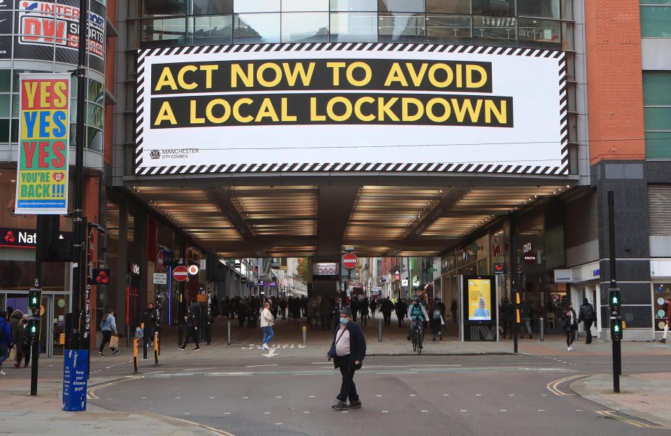 A coronavirus information sign sign in Manchester city centre. Cities in northern England and other areas suffering a surge in Covid-19 cases may have pubs and restaurants temporarily closed to combat the spread of the virus. (Photo by Danny Lawson/PA Images via Getty Images)