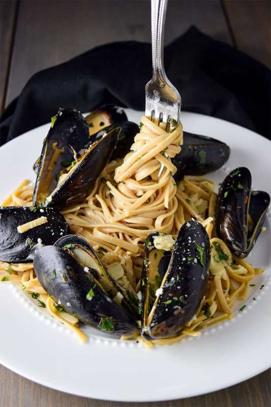 <p>Kitchen Swagger</p><p>Mussels over pasta with light, yet creamy white wine sauce made with garlic, butter, fresh basil, Parmesan cheese, and cream. Tossed with linguine and simmered until creamy.</p><p><strong>Get the recipe: <a href="https://kitchenswagger.com/mussels-linguine-garlic-butter-sauce-recipe/" rel="nofollow noopener" target="_blank" data-ylk="slk:Mussels and Linguine with Garlic Butter Sauce;elm:context_link;itc:0;sec:content-canvas" class="link rapid-noclick-resp">Mussels and Linguine with Garlic Butter Sauce</a></strong></p>