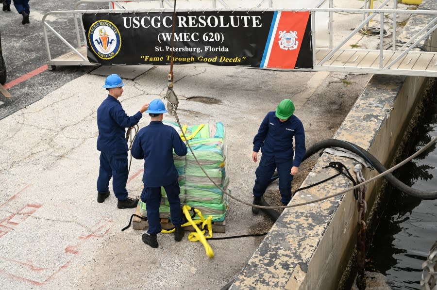 Crew of the Coast Guard Resolute unload interdicted narcotics on the pier, Jan. 29, 2024, St. Petersburg, FL. The drugs were forklifted onto trucks for destruction. (U.S. Coast Guard photo by Petty Officer 3rd Class Nicholas Strasburg)