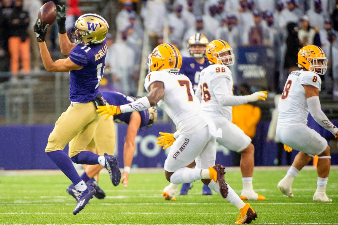 Washington wide receiver Jalen McMillan (11) catches a pass from quarterback Dylan Morris (9) as Arizona State defensive back Timarcus Davis (7) defends during the first quarter of a Pac-12 game on Saturday evening at Husky Stadium in Seattle.