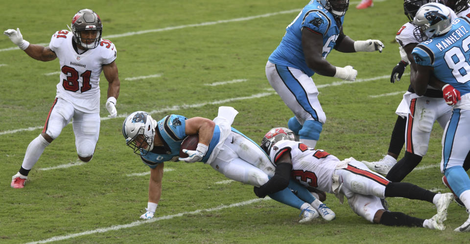 Carolina Panthers running back Christian McCaffrey (22) gets tripped up by Tampa Bay Buccaneers free safety Jordan Whitehead (33) during the second half of an NFL football game Sunday, Sept. 20, 2020, in Tampa, Fla. (AP Photo/Jason Behnken)