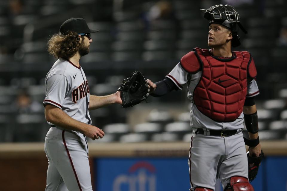 May 7, 2021; New York City, New York, USA; Arizona Diamondbacks starting pitcher Zac Gallen (23) walks off the field with catcher Carson Kelly (18) after the sixth inning against the New York Mets at Citi Field.