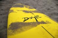 Doyle surfboards lie on the beach at a surf camp in Malibu