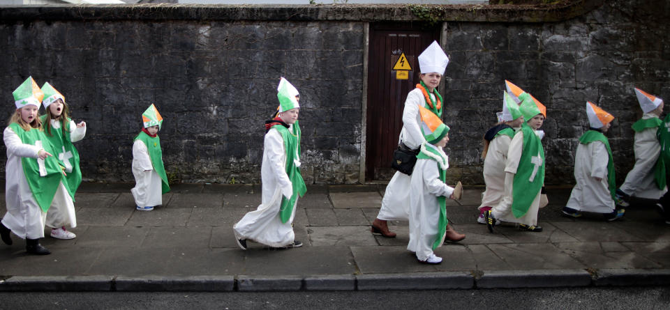 Children dressed as St Patrick make their way to the St Patrick's Day parade in Limerick, Ireland, Sunday, March 17, 2013. (AP Photo/Peter Morrison)