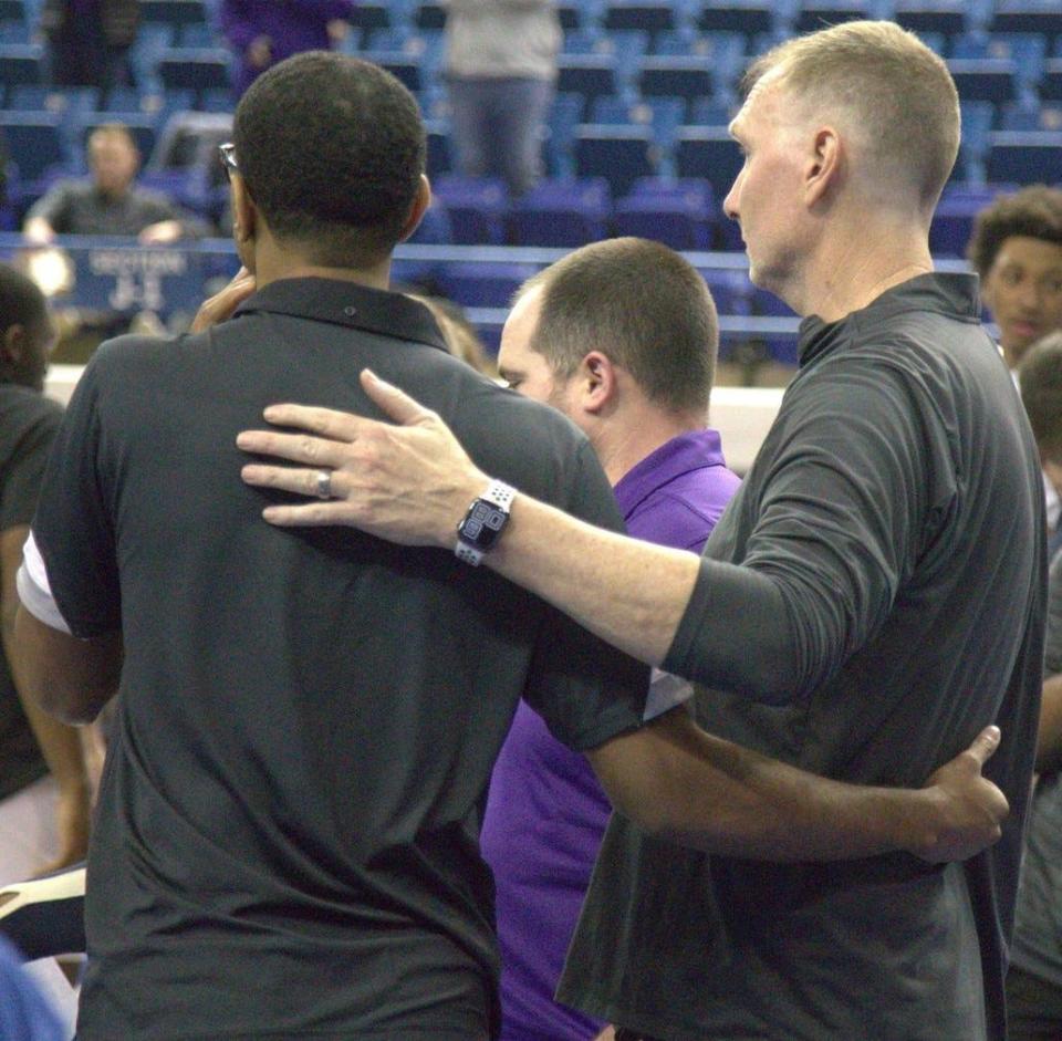 Tennessee State basketball coach Brian "Penny" Collins, left, and Tennessee Tech coach John Pelphrey watch as medical personnel attend to Golden Eagles basketball player Diante Wood, who suffered an injury with 3:04 left to play and was taken to Vanderbilt Medical Center.