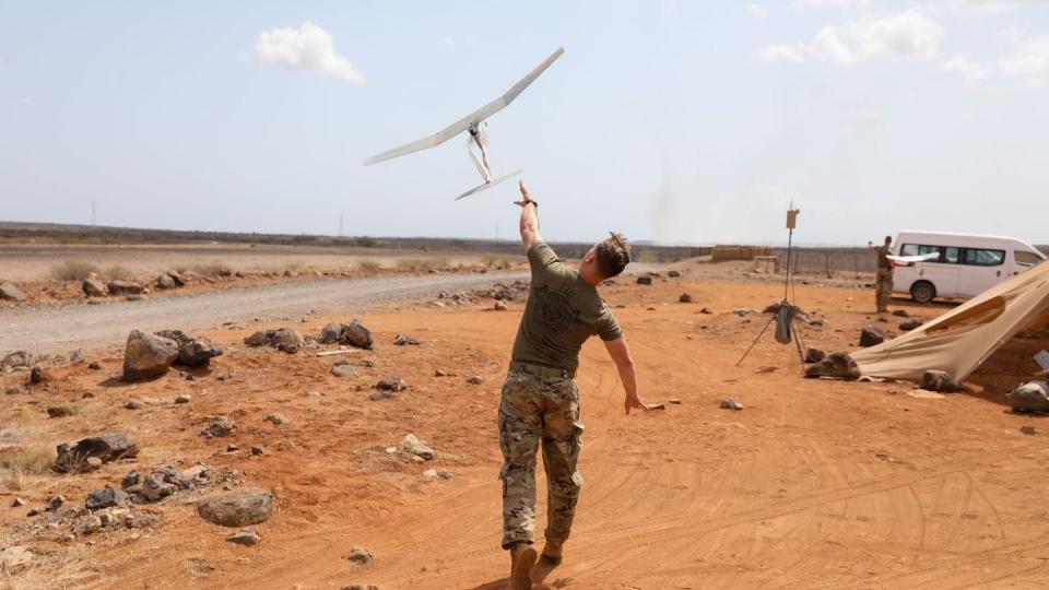 U.S. Army Spc. William Ellison launches an RQ-11 Raven drone during an operators course at Chabelley Airfield, Djibouti, on Oct. 13, 2021. (Pfc. Gauret Stearns/U.S. Army)