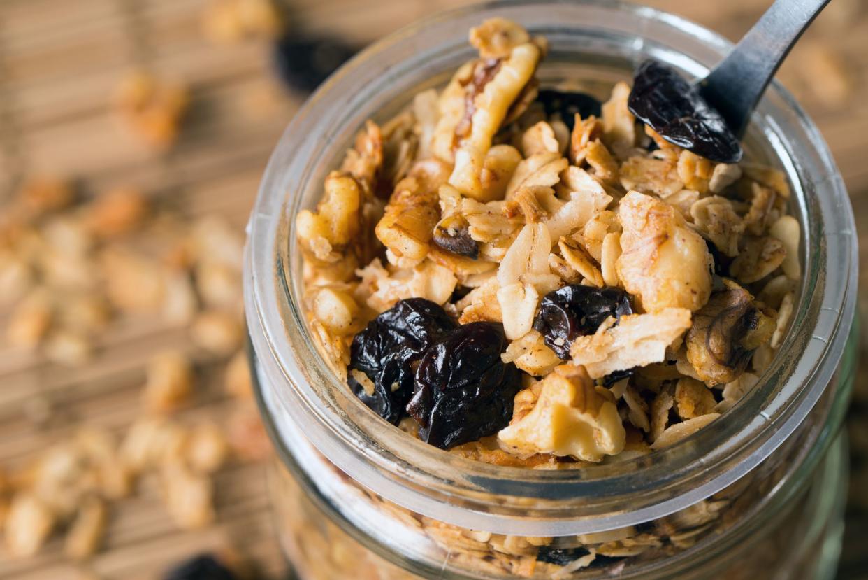 Homemade granola in a glass jar with selective focus, healthy vegan snack