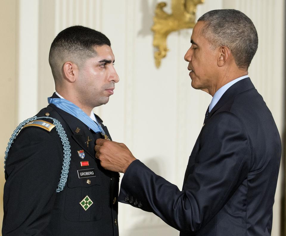 President Barack Obama adjusts the Medal of Honor after bestowing the nation's highest military honor, to retired Army captain Florent Groberg