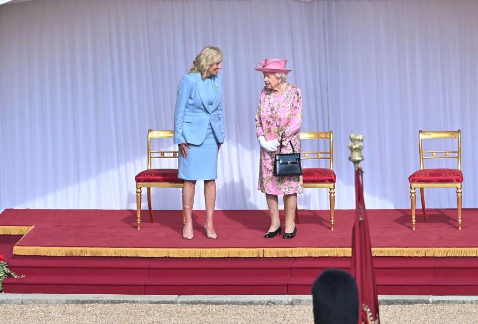 <p>For the occasion, Dr. Jill Bidn wore a powder blue suit and nude heels while the Queen wore a pink floral dress and a matching hat. </p>