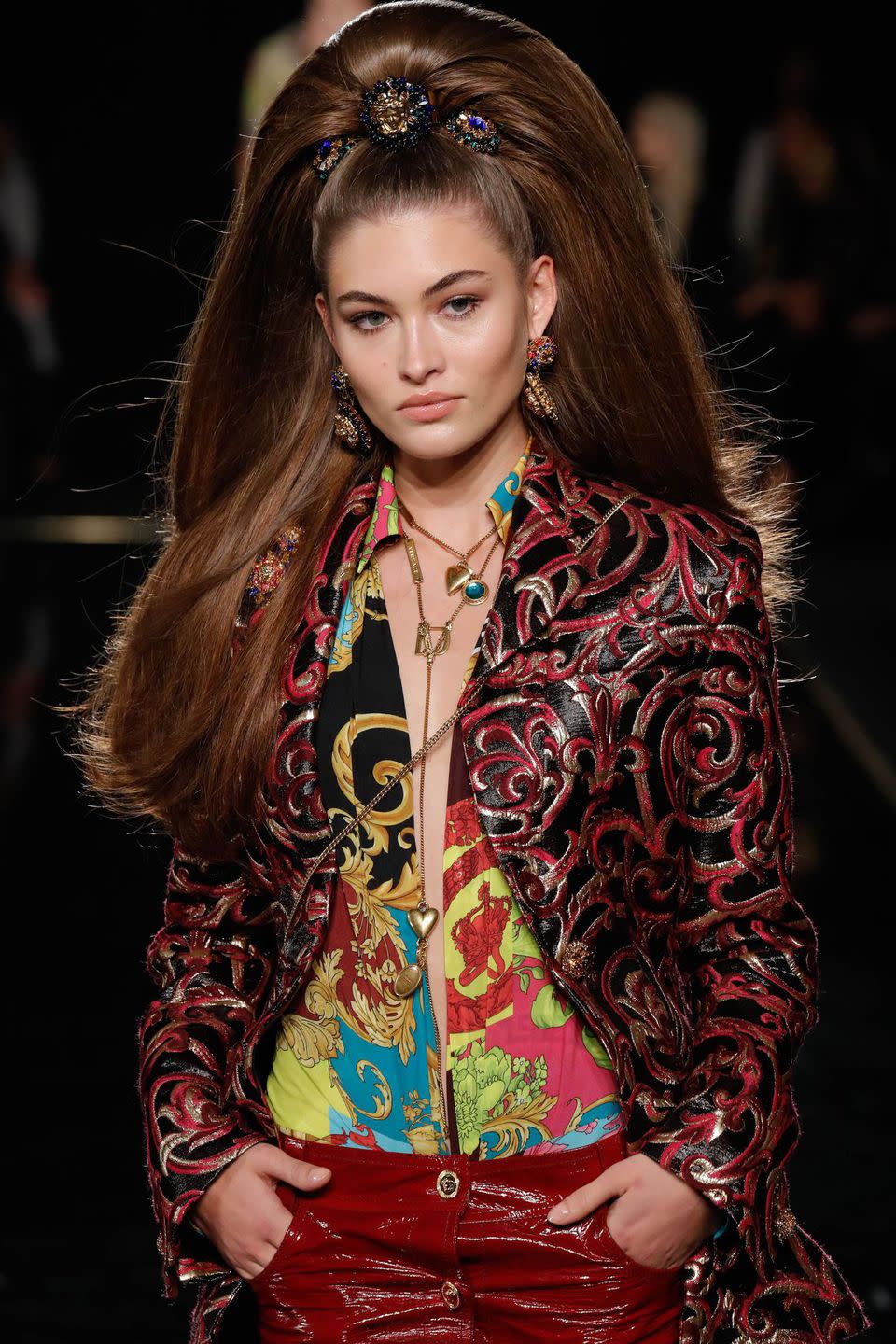 <p>There's big hair-and then there's the hair seen on the pre-fall 2019 Versace runway last night. Model Grace Elizabeth's hair was pulled into a super-high ponytail, decorated with three Versace brooches, and then pounds of fake hair were added in for the sky-high cascading effect. The look was reminiscent of the latest Valentino runway, where model Kaia Gerber stormed the catwalk in hair so voluminous you could practically see it from the ISS.</p>