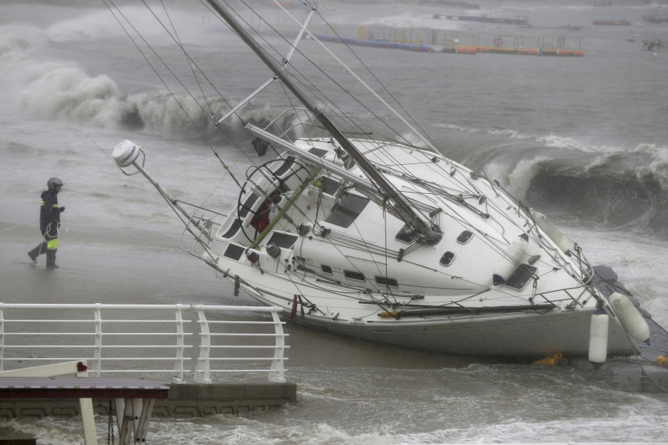 In this Sunday, Sept. 22, 2019, photo, a yacht is pushed ashore by strong winds and high waves at a beach as Typhoon Tapah approaches in Ulsan, South Korea. The powerful typhoon has battered southern South Korea after lashing parts of Japan’s southern islands with heavy rains and winds. (Kim Yong-tae/Yonhap via AP)