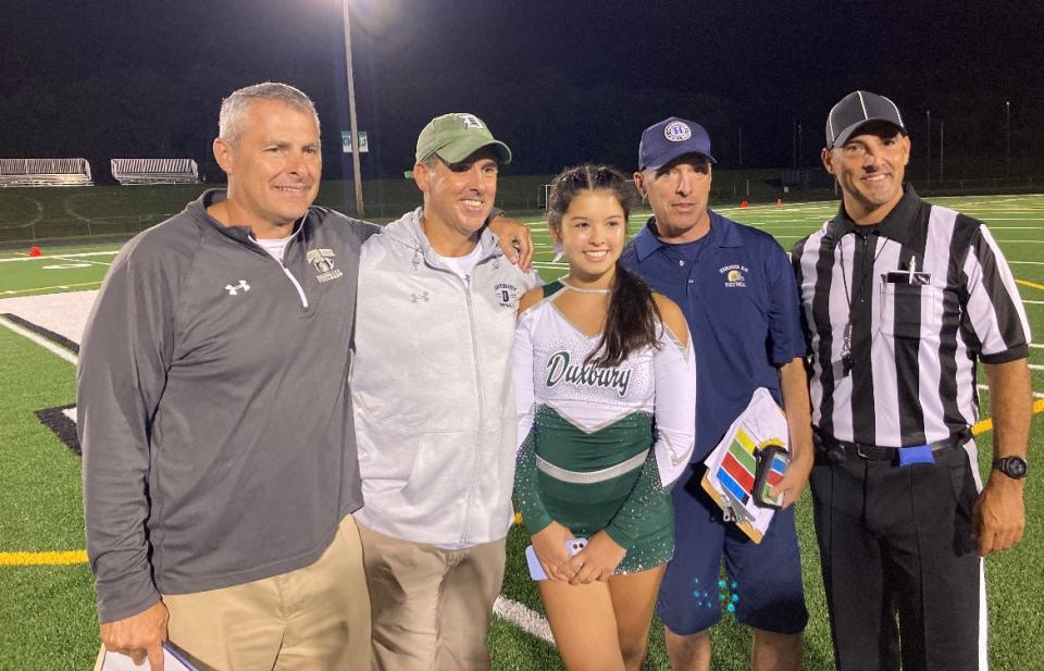 Four of the five Landolfi brothers were at Duxbury High on Thursday night for the opening game of the football season. From left, Mark Landolfi, Hanover's special teams coach; Matt Landolfi, Duxbury's head coach; Madison Landolfi; Matt's daughter, a cheerleader; Chris Landolfi, Hanover's head coach; and Brian Landolfi, a game official.