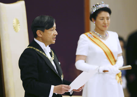 Japan's Emperor Naruhito, flanked by Empress Masako, delivers a speech during a ceremony called Sokui-go-Choken-no-gi, his first audience after the accession to the throne, at the Imperial Palace in Tokyo, May 1, 2019, in this photo released by Kyodo. Mandatory credit Kyodo/via REUTERS