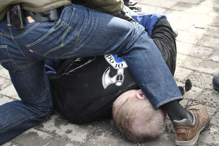 A man is detained after trying to hit Finnish Foreign Minister Timo Soini at the Korson Maalaismarkkinat country fair in Vantaa, Finland March 24, 2019. Lehtikuva/Heikki Saukkomaa via REUTERS ATTENTION EDITORS - THIS IMAGE WAS PROVIDED BY A THIRD PARTY. NO THIRD PARTY SALES. NOT FOR USE BY REUTERS THIRD PARTY DISTRIBUTORS. FINLAND OUT. NO COMMERCIAL OR EDITORIAL SALES IN FINLAND.