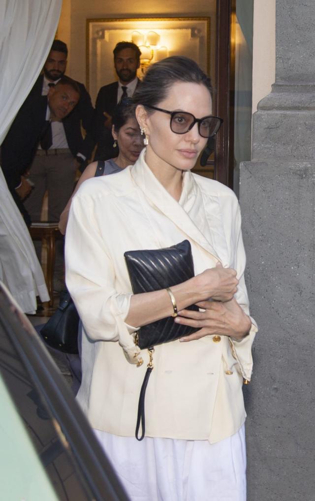 Angelina Jolie looks elegant in black as she walks through airport