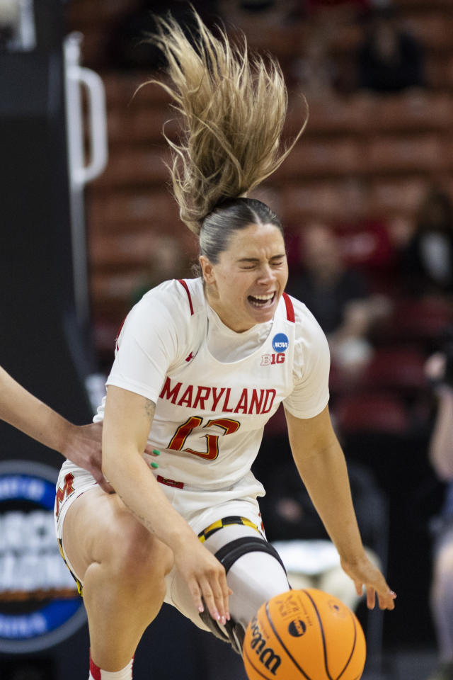 Maryland's Faith Masonius (13) reaches for a loose ball over Notre Dame defenders in the first half of a Sweet 16 college basketball game of the NCAA Tournament in Greenville, S.C., Saturday, March 25, 2023. (AP Photo/Mic Smith)
