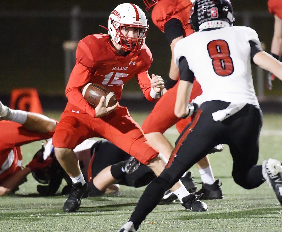 General McLane senior Dylan Sheeder (15) runs near Hickory sophomore Zander Telesz during a District 10 Class 3A quarterfinal at PennWest University in Edinboro on Friday night.