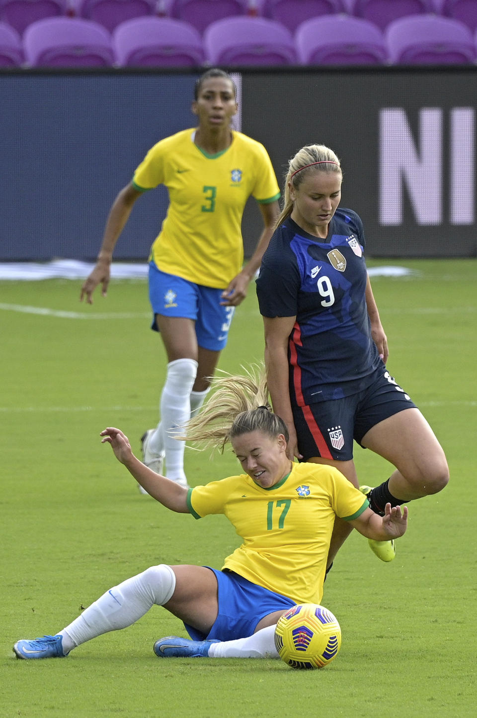 Brazil midfielder Andressinha (17) and United States midfielder Lindsey Horan (9) collide while competing for a ball during the first half of a SheBelieves Cup women's soccer match, Sunday, Feb. 21, 2021, in Orlando, Fla. (AP Photo/Phelan M. Ebenhack)