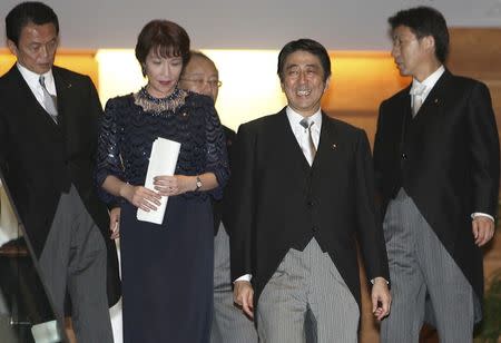 Japanese Prime Minister Shinzo Abe (2nd R) smiles as he leads then Foreign Minister Taro Aso (L), Gender Equality Minister Sanae Takaichi (2nd L), Justice Minister Jinen Nagase (3rd L) and Chief Cabinet Secretary Yasuhisa Shiozaki (R) during a photo session at the premier's official residence in Tokyo, in this September 26, 2006 file photo. REUTERS/Toru Hanai/Files