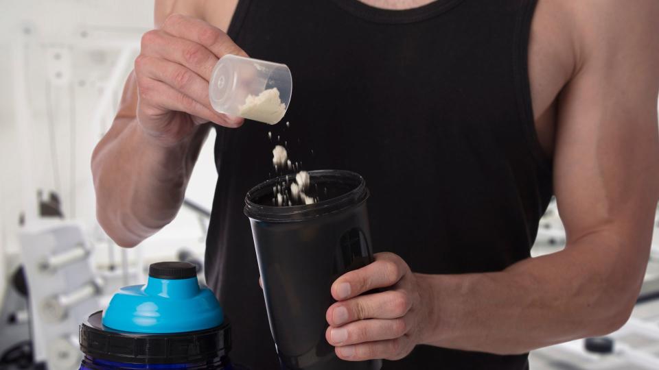 Man preparing a pre-workout drink