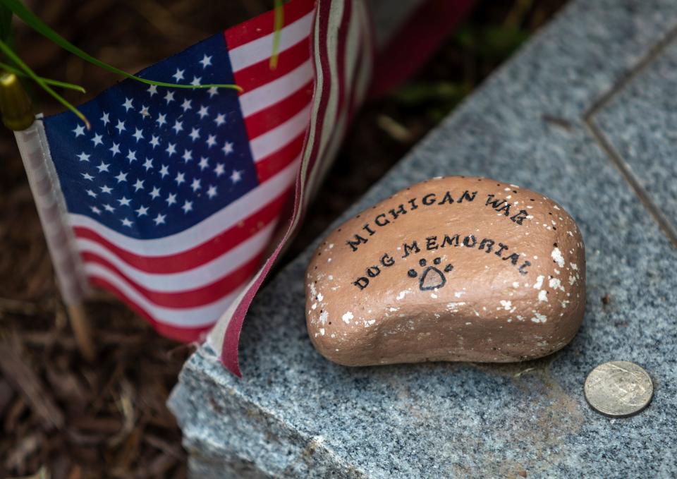 A rock with the words Michigan War Dog Memorial sits on top of a K-9 tombstone inside the Michigan War Dog Memorial in South Lyon on June 14, 2023.