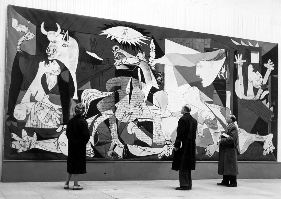 Visitors to the Picasso exhibition in Munich, Germany, in October 1955 look at the famous painting 'La Guernica' by Pablo Picasso.<span class="copyright">Georg Goebel—Picture Alliance/Getty Images</span>
