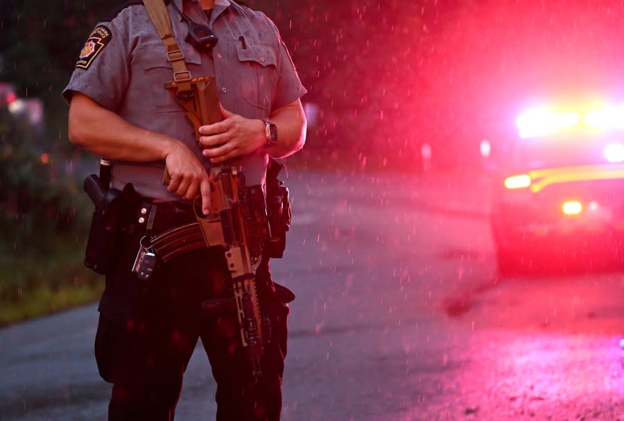 KENNETT SQUARE, PENNSYLVANIA – SEPTEMBER 9: Police with rifles monitor a wooded perimeter in the rain on day 10 of a manhunt for convicted murderer Danelo Cavalcante on September 9, 2023 in Kennett Square, Pennsylvania. Cavalcante escaped from Chester County Prison on August 31. (Photo by Mark Makela/Getty Images)