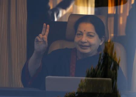 J. Jayalalithaa, chief minister of Tamil Nadu and chief of Anna Dravida Munetra Khazhgam (AIADMK), gestures from inside a vehicle after addressing her party supporters during an election campaign rally in Chennai April 19, 2014. REUTERS/Babu/Files