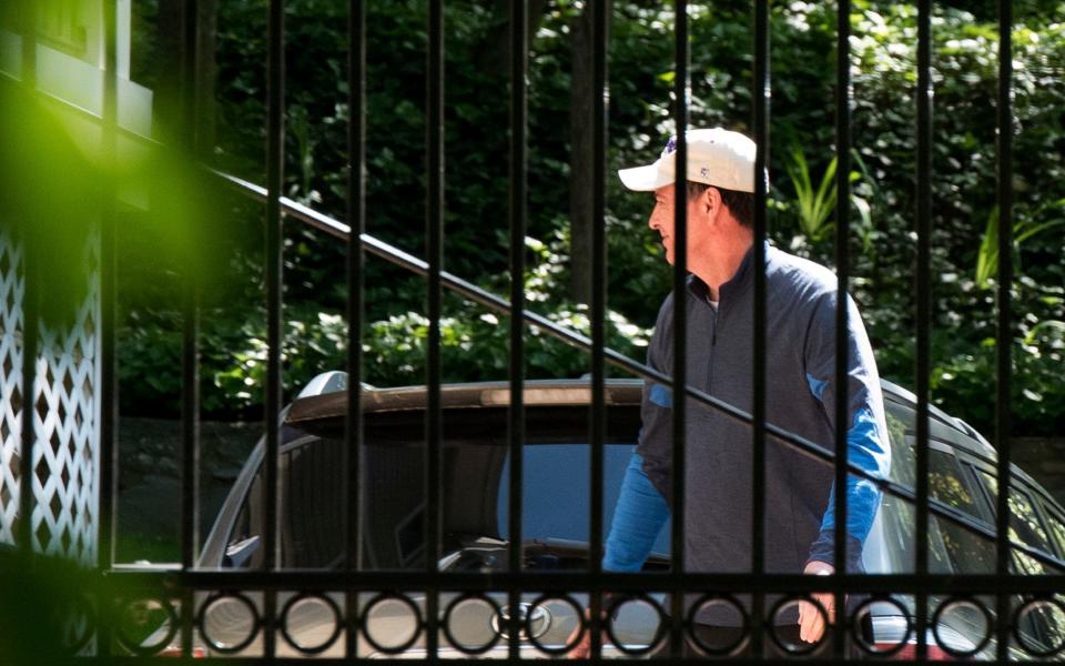 Former FBI Director James Comey walks at his home in McLean, Virginia - Credit: AP