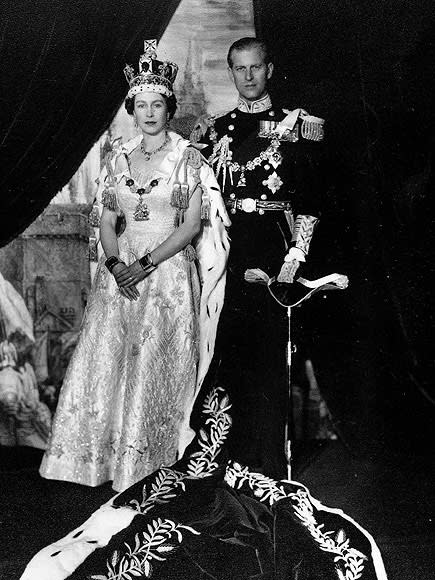 Queen Elizabeth wearing the Imperial State Crown and wearing her Coronation dress as she poses with her husband Prince Philip, Duke of Edinburgh after her coronation at Westminster Abbey on June 2, 1953 | Popperfoto/Getty Images