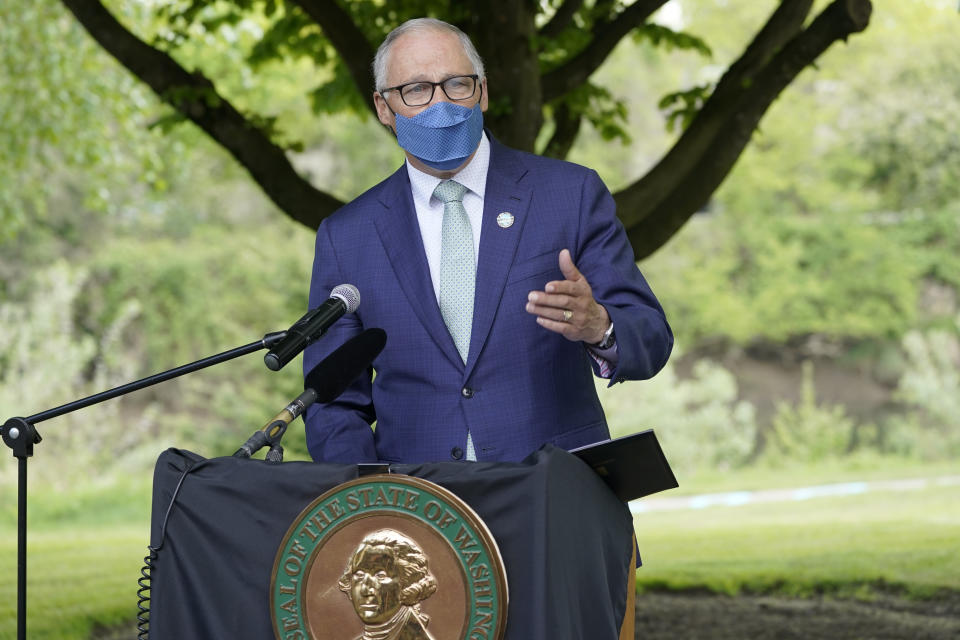 Washington Gov. Jay Inslee speaks before signing a bill into law in Tukwila, Wash., Tuesday, May 4, 2021, that levies a new capital gains tax on high profit stocks, bonds and other assets for some residents of Washington state. (AP Photo/Ted S. Warren)