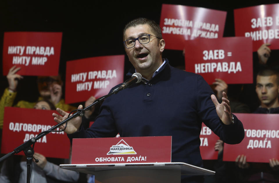 Hristijan Mickoski, leader of the opposition conservative VMRO-DPMNE party, gives a speech to supporters during a protest in front of the complex of national courts, in Skopje, North Macedonia, Tuesday, Feb. 25, 2020. Thousands of conservative opposition party supporters were marching in North Macedonia's capital Skopje late on Tuesday, accusing the outgoing leftist government for strongly influencing prosecution and court decisions. (AP Photo/Boris Grdanoski)